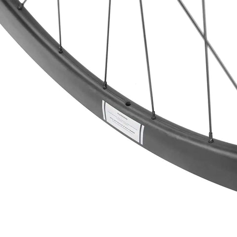 Close-up of Carbon Disc Brake Wheelset 700c 50mm By 25mm Tubeless Ready For Road Biking Paint Free Finish Toray T700 Fiber EN Certified