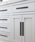 10 Pack Matte Black L Shaped Cabinet Pulls 7.48 Inch Overall Length 6.3 Inch Center To Center installed on white cabinets