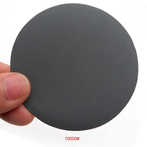 Top Shelf 30 Pack 3 Inch Hook Loop Sanding Discs Waterproof Silicon Carbide Rounds 60 To 10000 Grit Wet Dry Sandpaper For Steel Wood Glass Deburring That Gets It Done Fast - 10000 grit sanding disc held in hand.
