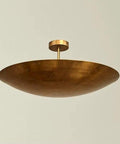Luxury Handcrafted Brass Pendant Light, Vintage Dome Ceiling Fixture featuring a sleek, wide dome shape and smooth raw brass finish.