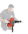 Man using Heavy Duty Cordless Drain Snake With Brushless Motor And Twenty Five Foot Steel Cable Blasts Away Stubborn Clogs tool.