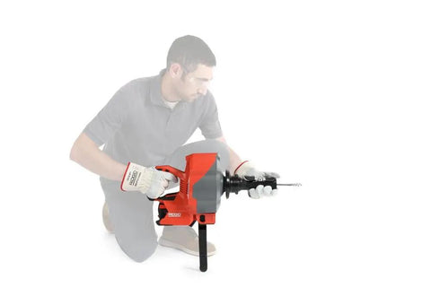 Man using Heavy Duty Cordless Drain Snake With Brushless Motor And Twenty Five Foot Steel Cable Blasts Away Stubborn Clogs tool.