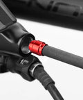 Close-up of Pro Grade Bicycle Brake Olive Connecting Insert Kit for Avid SRAM Hydraulic Disc Brakes in red, installed on hose.