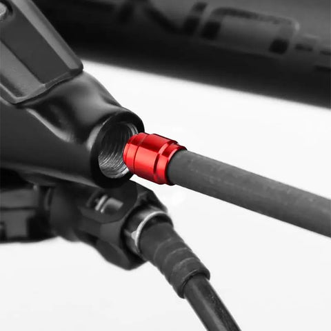 Close-up of Pro Grade Bicycle Brake Olive Connecting Insert Kit for Avid SRAM Hydraulic Disc Brakes in red, installed on hose.