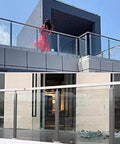 Stainless Steel 304 Railing Post Kit For Outdoor Decks And Stairs Featuring Adjustable Mounts And A Brushed Silver Finish Fit For 10 To 12 Mm Glass Panels, installed along a modern balcony.