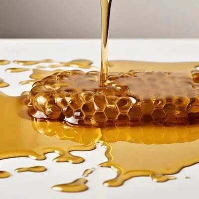 Honeycomb with dripping golden honey on a smooth surface, illustrating the nonstick quality of Terpene-Resistant PTFE Roll For Chef-Grade Kitchens And Lab-Precision Extractions.