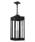 Lexington Extra Large 4 Light Natural Brass Outdoor Pendant Lantern With Clear Glass In Bold Art Deco Shape On Handcrafted Solid Brass Frame hanging securely with a chain.