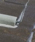 Heavy Duty Water Based Concrete Sealer And Cure Compound Hella Tough For Driveways Patios And Garages being applied with a paint roller.