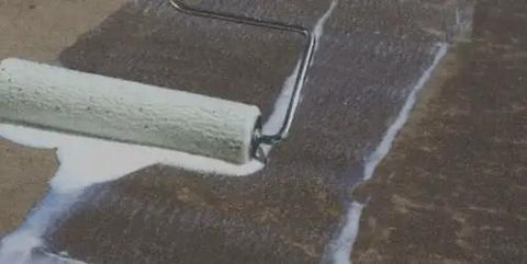 Heavy Duty Water Based Concrete Sealer And Cure Compound Hella Tough For Driveways Patios And Garages being applied with a paint roller.