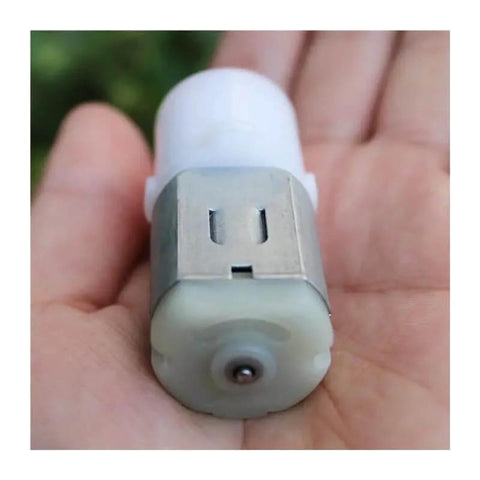 Small 280 Planetary Gearbox With Gear Brush Electronic Starter for DC Motors in hand, showing compact design and metal casing.