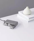 Three Battery Two Way Charging Station Hub For Mini 2 Drone with three batteries connected on a white table.