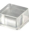 Close-up of a clear tall square self adhesive rubber foot pad, 0.78 inch wide by 0.38 inch high, for electronics and furniture.