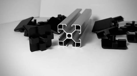 Eight Piece 4040 Aluminum Extrusion End Caps Heavy Duty Rock Solid Killer Grip Made In Usa T Slot Profile Plugs arranged with profile.