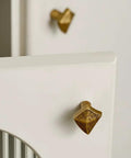 Antique Bronze Cabinet Knobs And Drawer Pulls Two Pack With Boho Geometric Silhouettes on white cupboard doors.