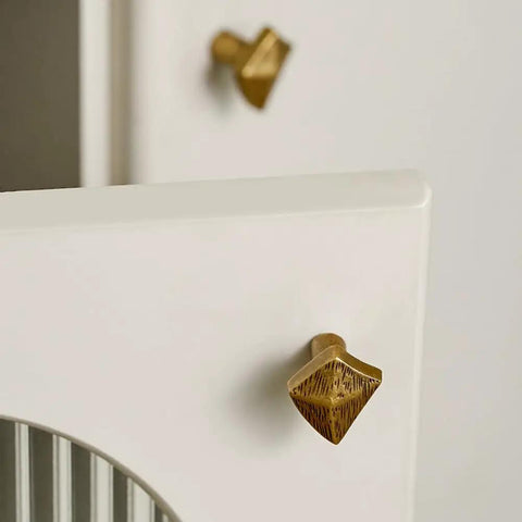 Antique Bronze Cabinet Knobs And Drawer Pulls Two Pack With Boho Geometric Silhouettes on white cupboard doors.