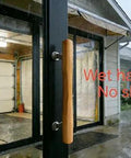 Natural Solid Wood Sliding Patio Door Handle With Ergonomic Curved Grip installed on patio door in rain