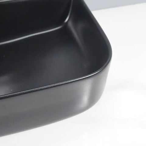 Close-up of USZWBY Vessel Sinks Bathroom Vessel Sink Black Ceramic Countertop Basin showing the smooth edges and finish.