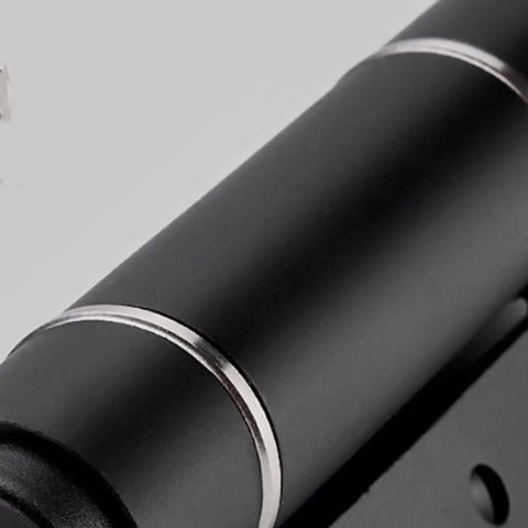 Close-up of Invisible Door Hinge With Automatic Closer And Hydraulic Spring Damping, sleek black finish for cabinets and furniture.