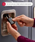 Master Lock black combination padlock — front view on locker hasp, hands adjusting the 3-digit code.