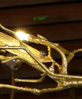 Close-up of the golden branch design of the Nine Light Art Branch Ceiling Pendant Light Featuring Chinese Zen Inspired Hanging Design And Durable Metal Build.