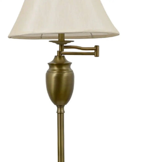 Close-up of Wellington Steel Swing Arm Floor Lamp In Antique Brass with faux silk shade and adjustable arm, modern design.