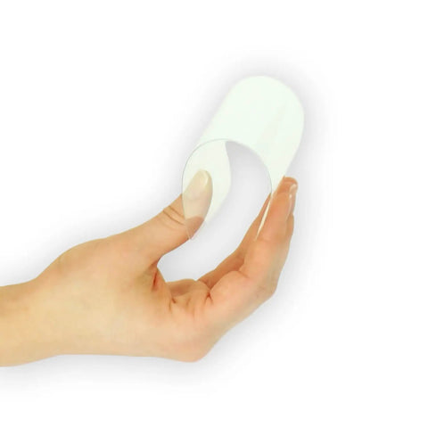 Top Shelf Hybrid Screen Protector For Wacom Stu 530 being held by hand, demonstrating its clear, flexible design and 9H armor.