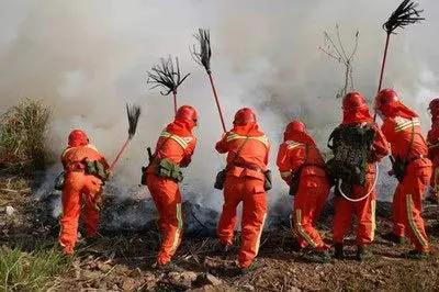 Heavy Duty Tough As Nails Red Fire Extinguisher With Long Handle Fire Mop Whip Pro Grade Emergency Safety Gear in action by firefighters.