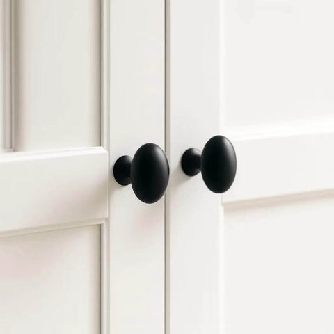 Oval Matte Black Cabinet Knobs 10 Pack For Kitchen And Furniture By EAXINTA installed on white cabinet doors