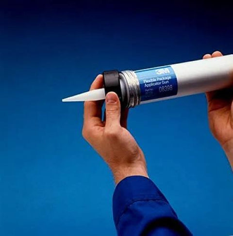 Hands holding marine-grade gray polyurethane sealant adhesive 20 oz (600 mL) sausage pack, ready for application, waterproof.