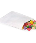 Half Pound White Paper Candy Bags 5.75 By 7.5 Inches Glassine Lined For Nuts Candies Treats Moisture And Oil Resistant Reusable Packaging For Party Favors Gift Bags Bulk Pack Of 300 filled with colorful candies.
