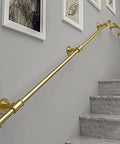 Hella Sturdy Gold Wrought Iron Handrail For Elderly And Kids Safety Stair Railing mounted on indoor staircase.