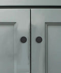 18 Pack 1-1/5 Inch Matte Black Round Cabinet Knobs Zinc Alloy Heavy Duty Pulls shown on grey cabinet doors