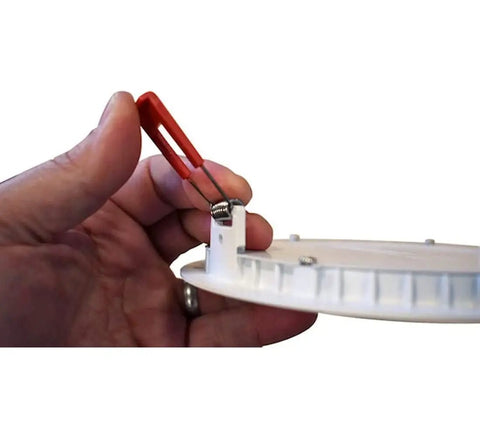 Hand holding spring clip of 6 Inch Recessed LED Wafer Downlight With Ultra Slim Round Trim Switchable Color Temperature 2700K 3000K 3500K 90 CRI Matte Black