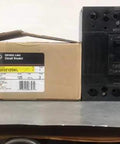 THQD32125WL Commercial Circuit Breaker With Bright Red Toggle For Quick Electrical Panel Swaps And Rock Solid Overload Shielding Built Damn Tough For Shop Floor Grind on a table next to its box.