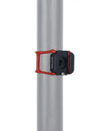 Beast Mode Hot Shoe Mount Adapter with Elastic Rubber Band wraps around a light pole, showcasing the sturdy attachment point.