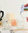 AdTech hot glue sticks, 4-inch mini size, clear; 30 sticks shown with glue gun for crafts.