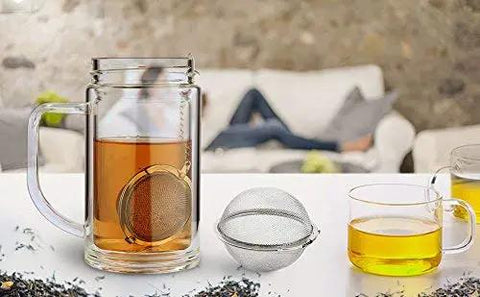 Glass cup with Two Pack 2.1 Inch Stainless Steel Mesh Tea Ball Infuser Strainer Filters For Teas Durable 304 Grade Tea Filter Basket displayed
