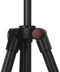 Close-up of a black camera tripod leg joint with a red accent, showcasing stability and design details.