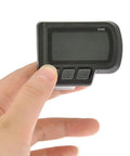 Hand holding EN06 display from Waterproof Bike Computer With LCD Screen And Speedometer For Electric Bikes And Scooters