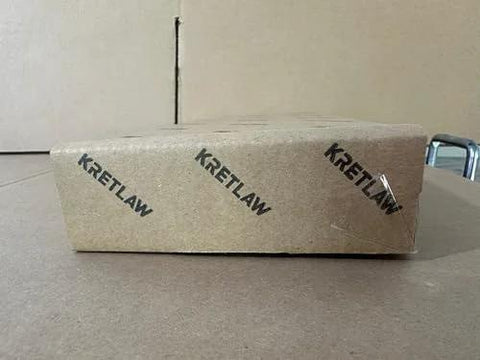 KRETLAW mini grease gun packaging box; brown cardboard with repeated KRETLAW logo.