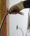 Top Tier Thhn Electrical Wire Featuring Six Awg White Black And Red Combined With Eight Awg Green Ground Stranded Copper Build Ul Certified For Rapid Shop Fixes Boss Level 25 Foot Spool Ready held in hand next to wall.