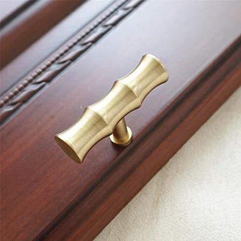 Bamboo Brass Kitchen Cabinet Knobs 52mm Long 30mm High TBar Pull Handles In Brushed Gold installed on wooden cabinet door