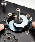 Hands adjusting the bit on a Heavy Duty 3.25 HP Soft Start Router Motor for precise woodworking.