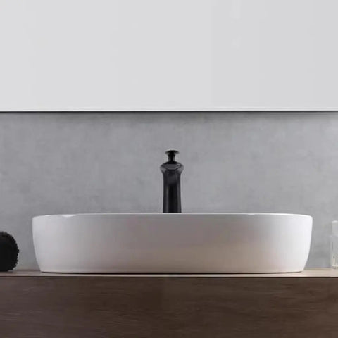 USZWBY Vessel Sinks Minimalist Ceramic Table Basin Home Hotel Bathroom Washbasin on wooden surface with dark faucet.