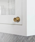 Antique Brass Cabinet Knobs With Gear Like Backplate Six Pack, Vintage Round Cup Design, installed on a white cabinet