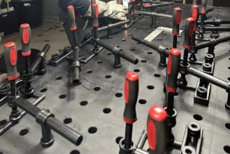 4-Pack 180 Degree Welding Fixture Screw Clamps for Five Eighth Inch Tables installed on workbench