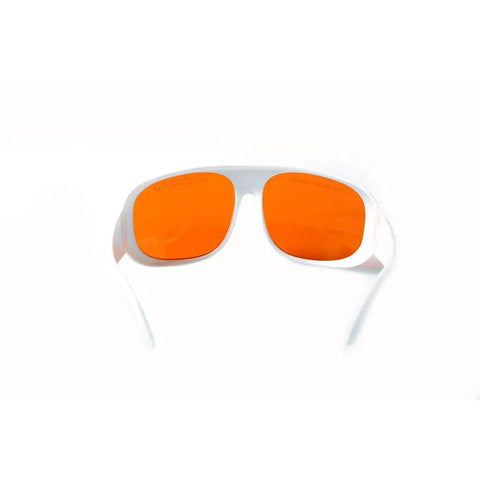 Top Shelf Heavy Duty Laser Safety Glasses Shielding Eyes From 532 Nanometer And 1064 Nanometer Beams With High Optical Density Rating For Lab And Workshop Use. Front view of orange-tinted glasses with white frame.