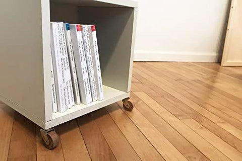 Small cabinet with Brown Wood Wheel Stem Casters Set Of Two With Friction Mount For Lightweight Furniture, hardwood floor background.