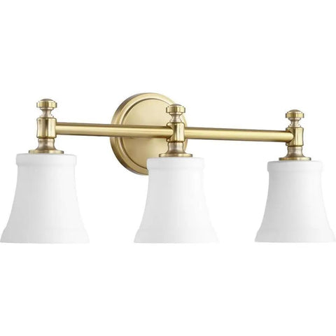 Transitional Three Light Vanity Light From Rossington Collection In Aged Brass Finish With Satin Opal Glass Damp Rated