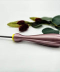 Quilling Bead Roller Tool Set With Slotted Winding Pins In Three Sizes Three Sixteenths Inch Five Thirty Seconds Inch And Five Sixty Fourths Inch For Diy Paper Jewelry Making Pink Pearl Silk Handle Color Coded Pin Bases And Bright Stainless Pins tool with yellow base on white surface.